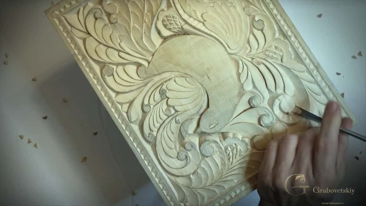 Gouge pressed in beside a round curl to the right of the bird