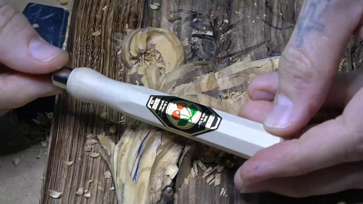 A red and green emblem on a white handle.